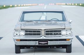 Beautiful, shiny muscle car on the road, with lights