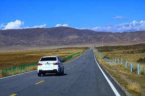 white car on the highway in Qinghai province