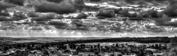 monochome panoramic photo of city and cloudy sky