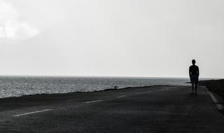 person on Road Pavement near Water