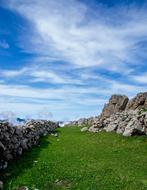 stones on green grass in a clear landscape