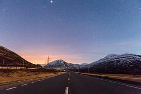 road against the background of mountains at dusk