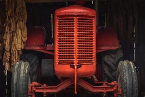 Front view of the orang, shiny tractor with the radiator