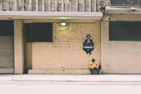 man sitting on paving slabs