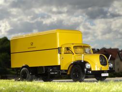 yellow mail truck on the road