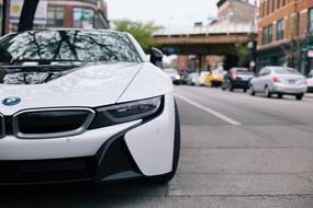 Beautiful white BMW i8 car on the road with other cars in Chicago