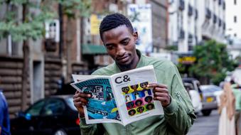 Portrait of Black man with Magazine