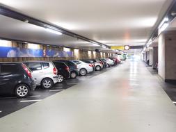 Colorful, shiny cars om the multi storey car park with lights