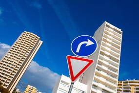 Buildings and colorful signs, under the blue sky with clouds, in Algarve, Portugal