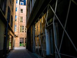 Landscape of the road, between the buildings in shadows and sunlight, in the city