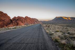 Beautiful landscape of the highway among the plants and mountains in the desert, at colorful and beautiful sky on background