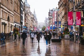 a crowd of people in the square during the rain