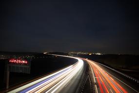 Landscape of the highway with the colorful lights in motion, at the night