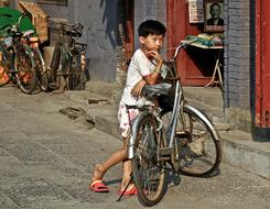 Child boy with Bike at house, China, luoyang
