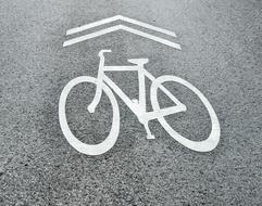 direction Sign with bicycle Symbol on Road