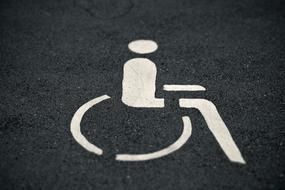 Close-up of the white mark of the disabled parking space, on the asphalt