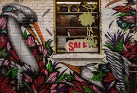 Wall with window, with the beautiful and colorful graffiti with flowers and leaves, in London, England