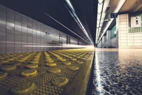 yellow coating on the subway platform