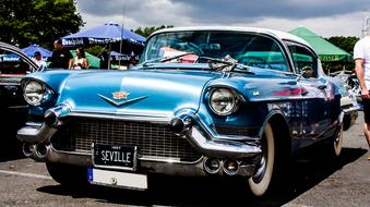 blue classic car at the auto show on a sunny day