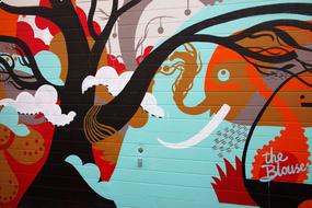 Colorful and beautiful graffiti with trees and creature, on the wall of the building