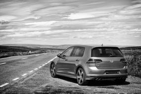 black and white photo of a Volkswagen on the side of the road