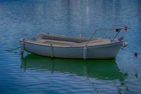 Boat on the colorful and beautiful water with ripple, with reflections