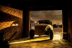 car beetle in the garage in the light and shadow