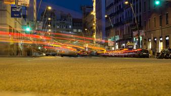 Cityscape of Barcelona, Spain with the colorful lights in motion, among the buildings, in the evening