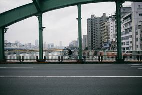 man cycling on Bridge in contemporary city