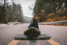 Girl Alone lying on road