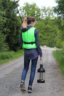 girl with Fishing rod and lantern walks away