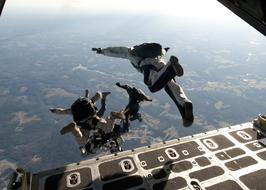 People on the military parachute training, above the landscape