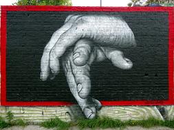 graffiti on the wall in the form of hands on a black background