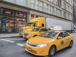 Different yellow vehicles on the road of Manhattan, New York, United States