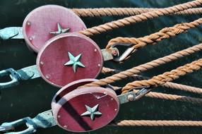 Close-up of the rigging pulleys with stars, in light