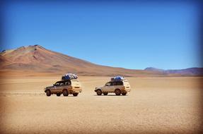 two yellow outlander cars in Desert