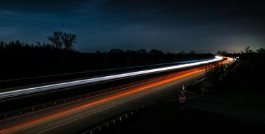 lights of high-speed cars on the highway at night