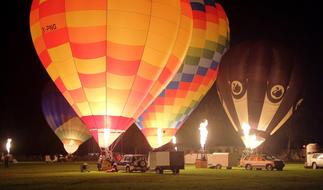 Hot Air Balloons Glow at Night