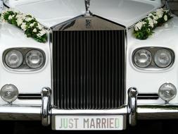 flowers on a white wedding car