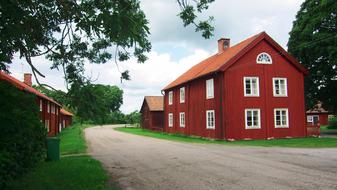 red farmhouse on the side of the road in Sweden