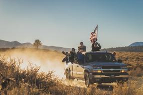 travel by pickup truck with american flag