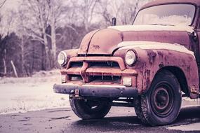 old rusty truck on city road