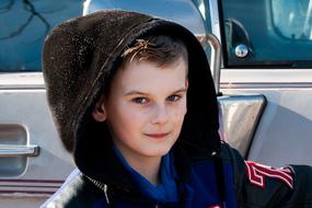 boy posing near vehicle