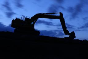 Night excavator at blue sky