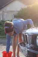 girl washes a car On the Sunset