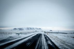 highway, fields, mountains in winter