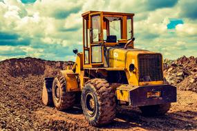 yellow bulldozer on a sand quarry