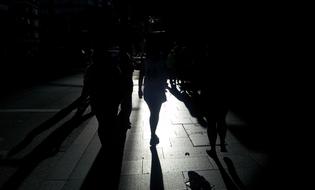 People on Street at night, silhouettes with Shadows