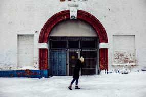 girl on the street near the building in winter