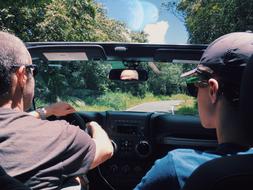 dad and son are traveling by car